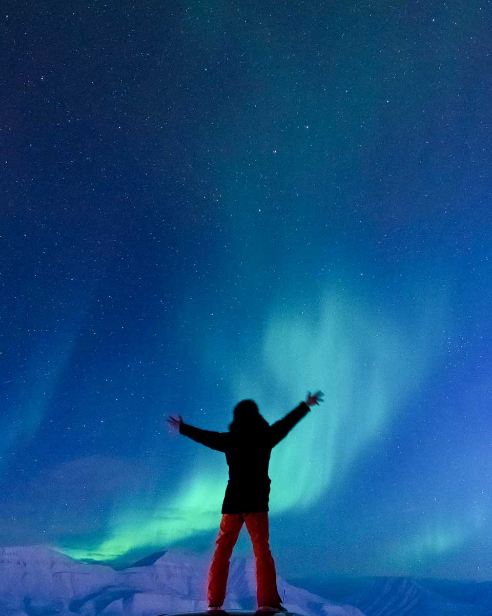 A-person-stands-looking-at-Aurora-Northern-Lights-on-a-tour-from-Anchorage-Alaska