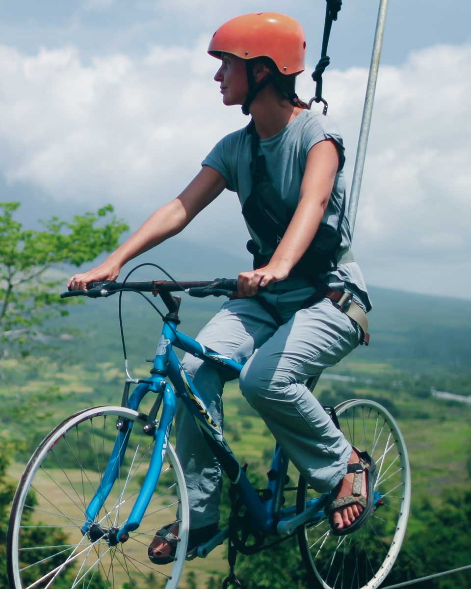 A woman on a bike zipline seen on a tour from San Salvador El Salvador