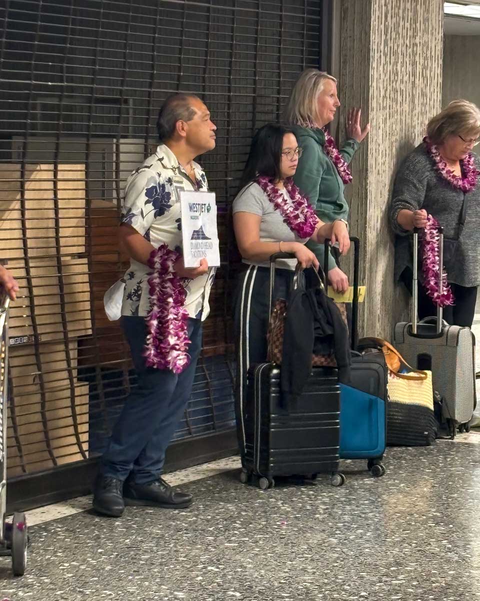 A man waits with leis in the Honolulu Airport in Oahu Honolulu Waikiki Hawaii (6)
