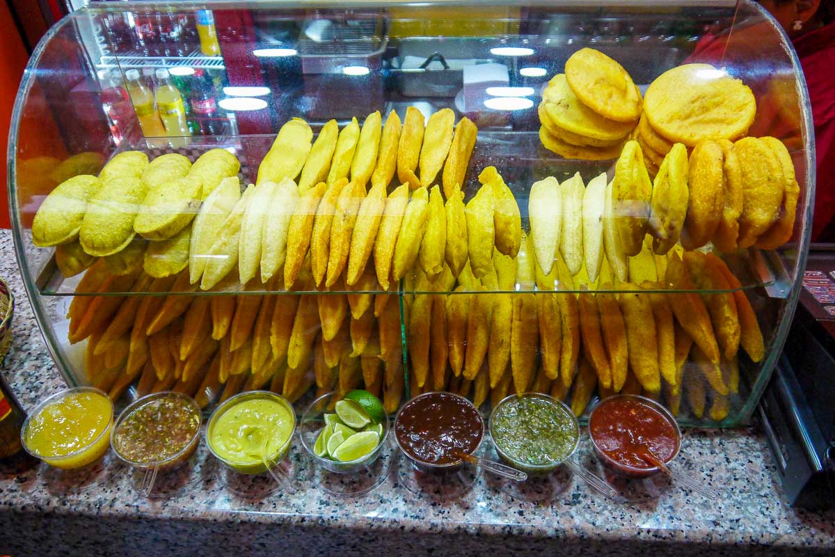 Various street foods and snacks seen on a food tour in Santa Marta Colombia
