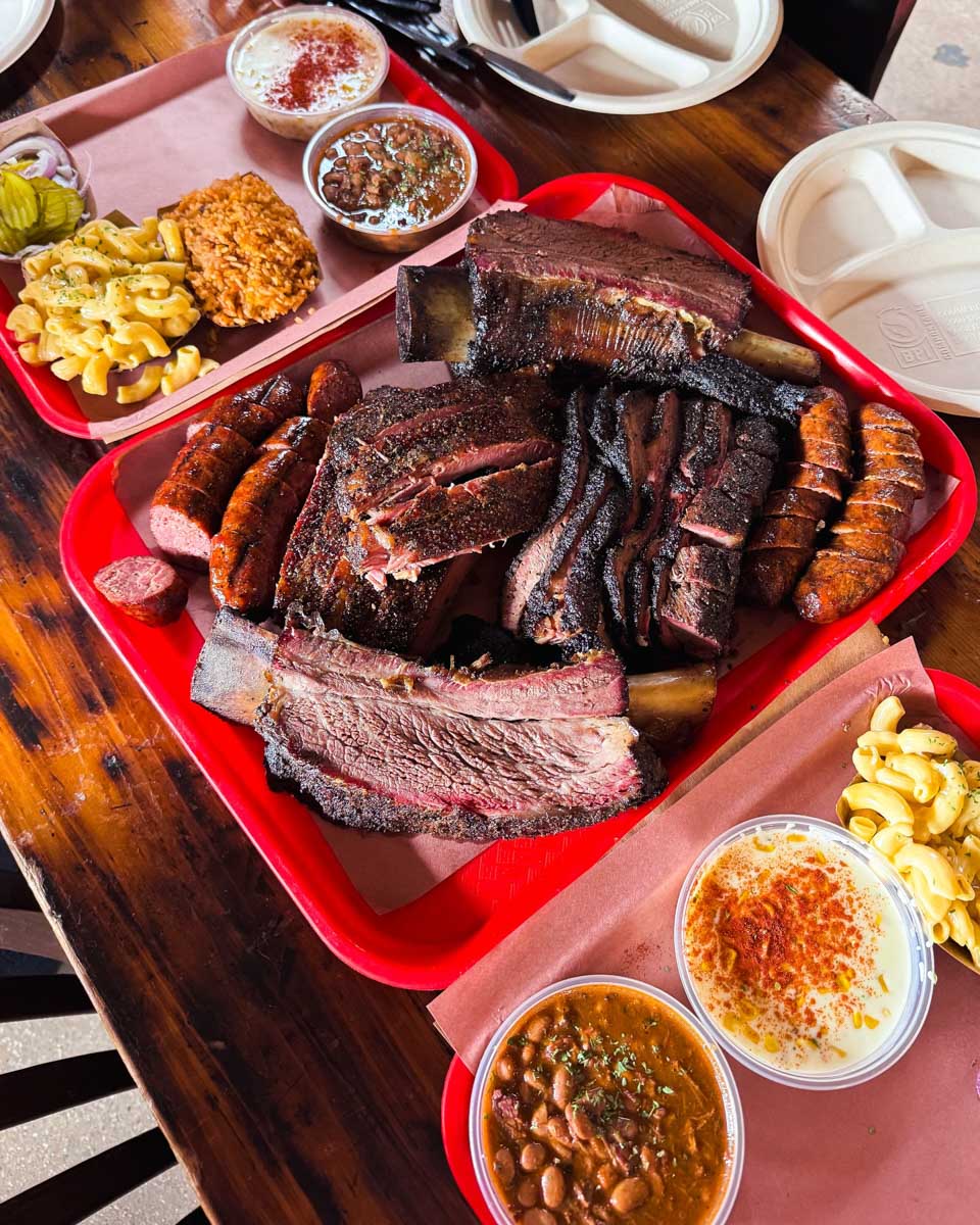A bunch of BBQ meat on the table at Terry Black's Barbecue in Dallas