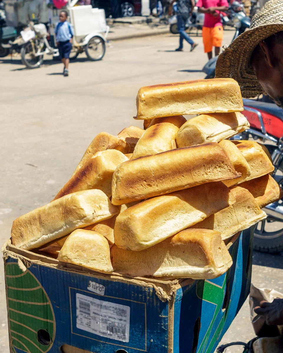 A-man-selling-bread-at-a-market-in-Zanzibar-Tanzania