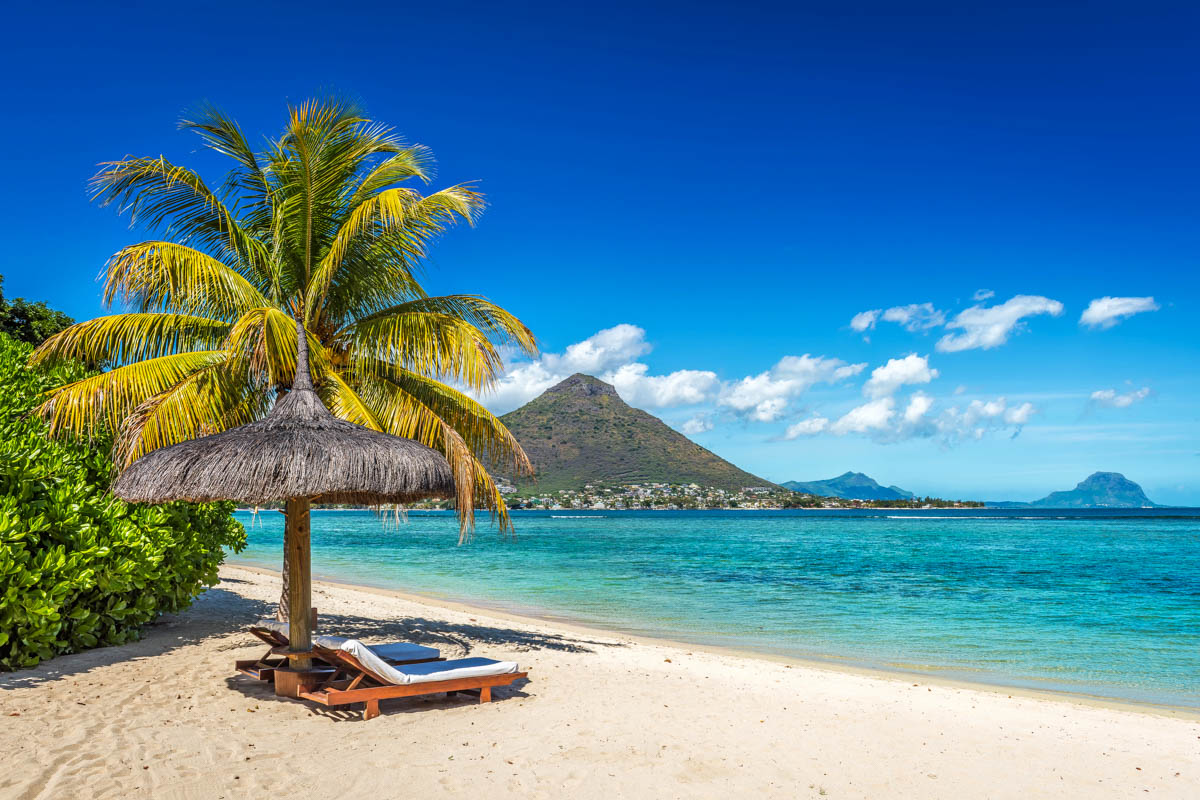 Loungers and umbrella on tropical beach in Mauritius