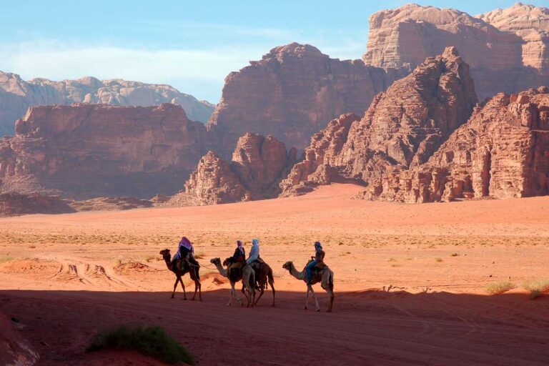 People on camels in Wadi Rum